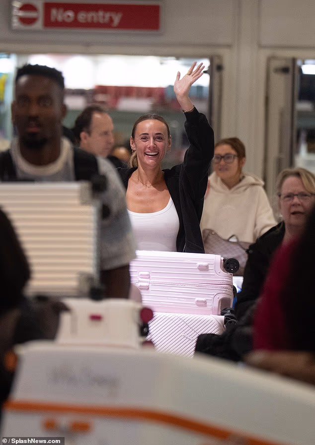 The TV personality appeared overjoyed to be back home, flashing a smile and a wave for the cameras