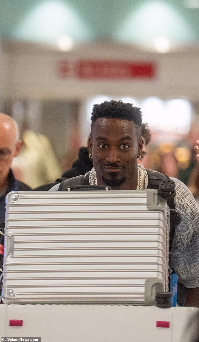 Yamen, 33, smiled for the cameras as he wheeled his luggage towards the exit