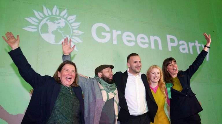 Spencer (second right) celebrates with party leader Polanski (centre) and supporters. Pic: AP