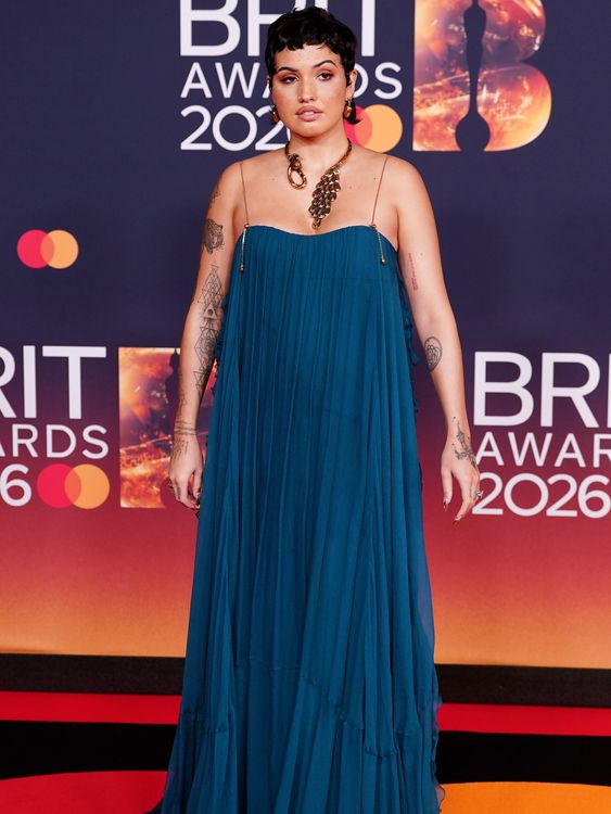 Mabel in a floor-length teal gown with gold accessories. Pic: PA 