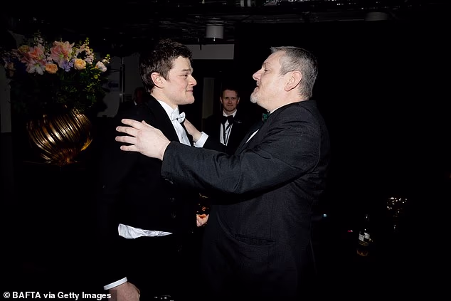 Robert Aramayo has jumped to the defence of Tourette's campaigner John Davidson who left the BAFTAs on Sunday after shouting racial slurs in the audience (pictured together