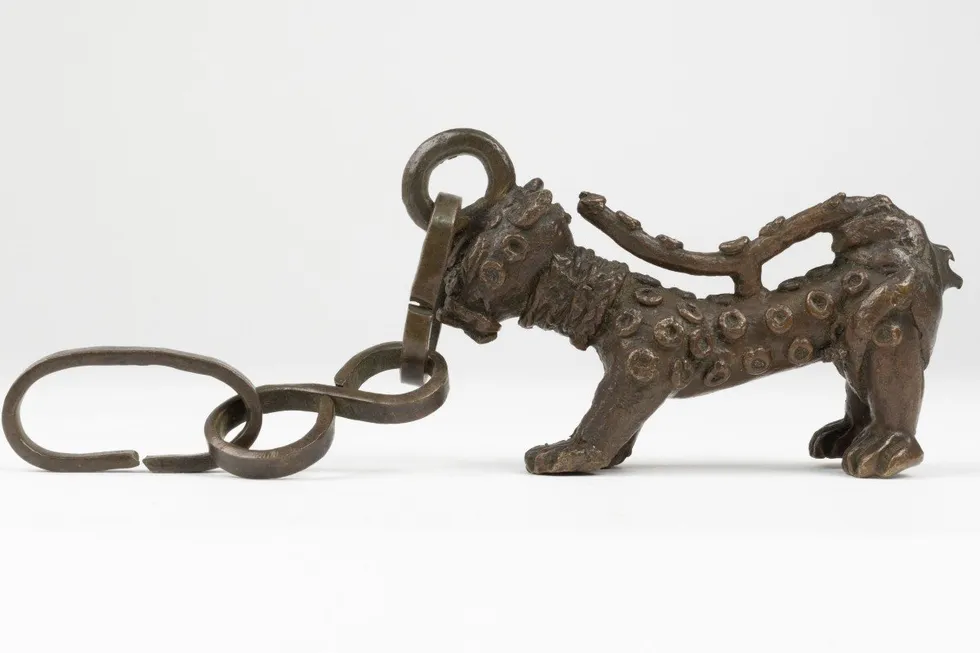 Benin Bronzes: Brass leopard with raised spots, attached by the head to a chain