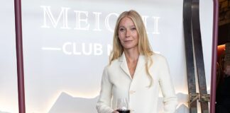 Gwyneth Paltrow looks chic in a sweeping white frock coat and skirt as she raises a glass at boozy pop-up launch – after facing backlash for recommending a non-invasive cancer treatment