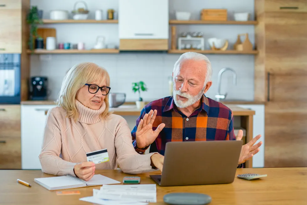pensioner couple at laptop with bills