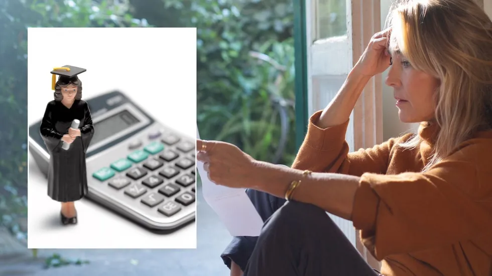 Woman looking at bill and calculator
