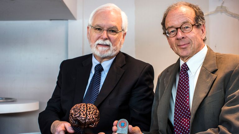 Prof Donoghue (L) receiving an award for work in brain tech in 2013. Pic: Reuters