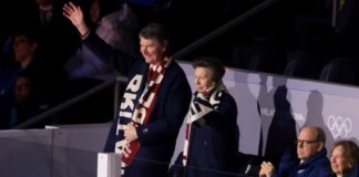 Princess Anne waves at fans alongside husband Sir Timothy Laurence at Winter Olympics opening ceremony