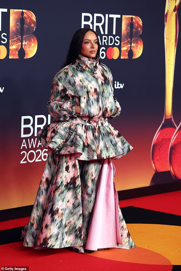 The singer wore a custom off-white patterned coat dress