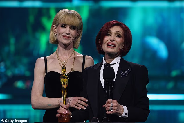 Sharon lovingly described her late husband as 'The most humble egomaniac you could ever meet' as Kelly stood supportively beside her