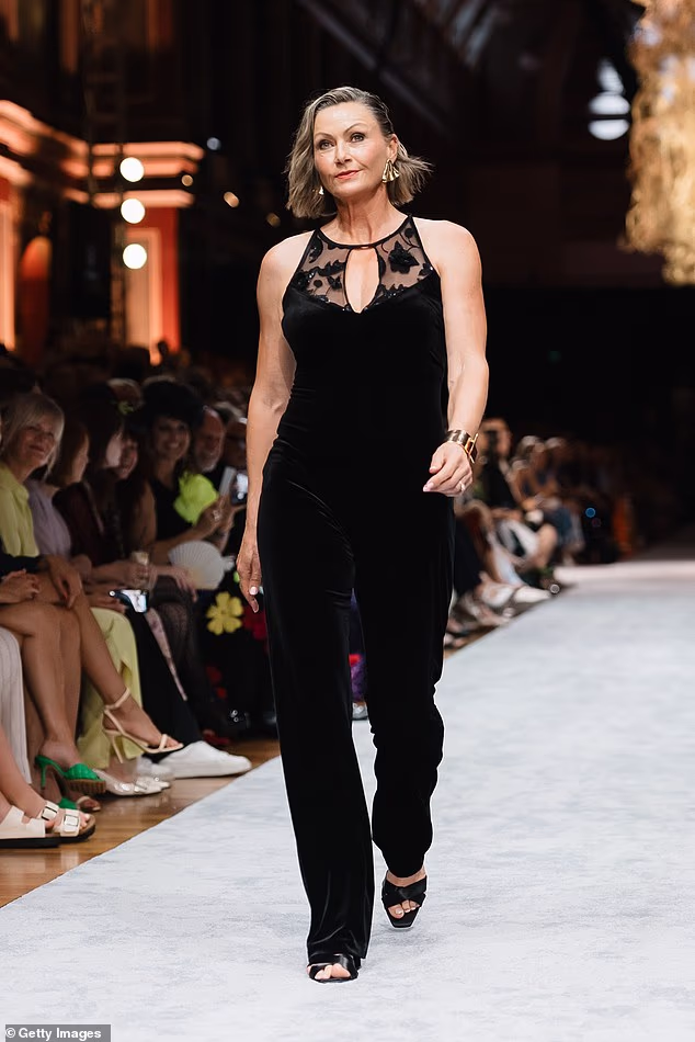 The 60-year-old stunned as she strutted her stuff in a semi-sheer black lace top paired with matching trousers