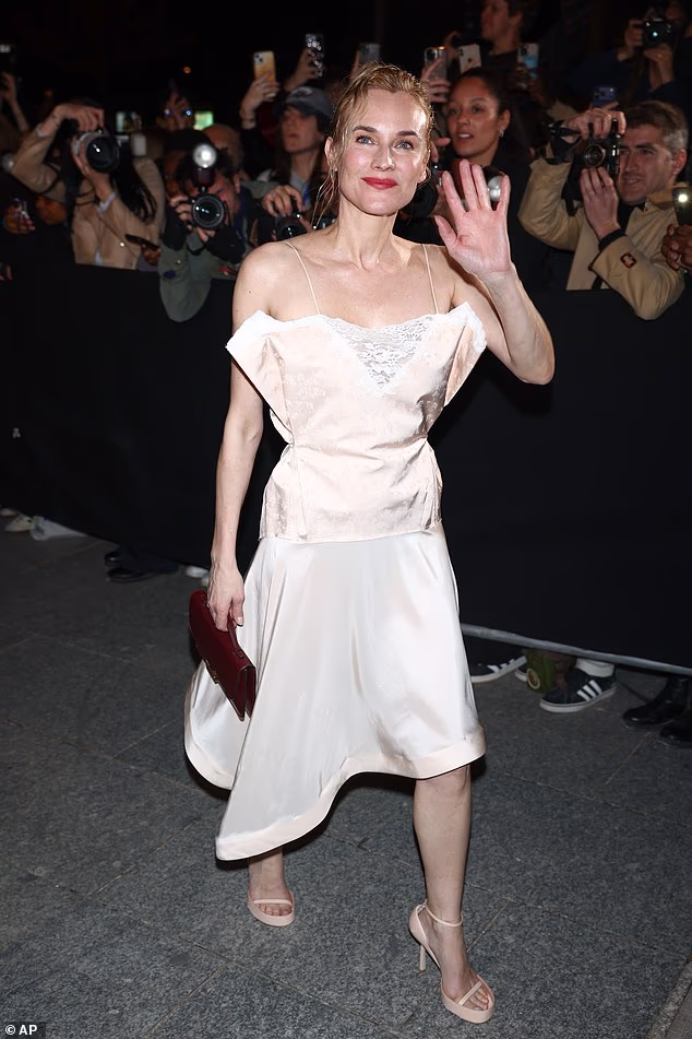 German actress Diane Kruger was seen arriving for the show in Paris as she donned a cream asymmetric dress featuring a lace cut-out bodice