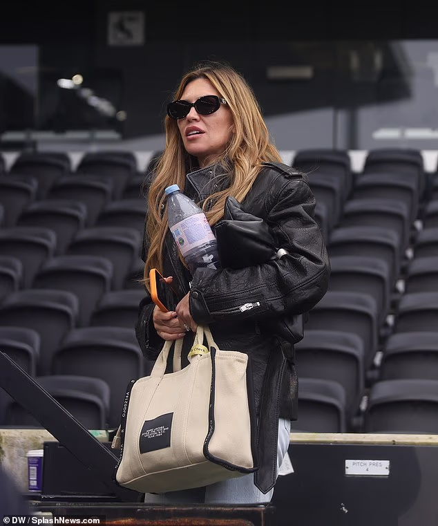 The model, 40, looked in good spirits as she rocked a stylish black leather jacket which she teamed with light blue denim jeans and brown trainers
