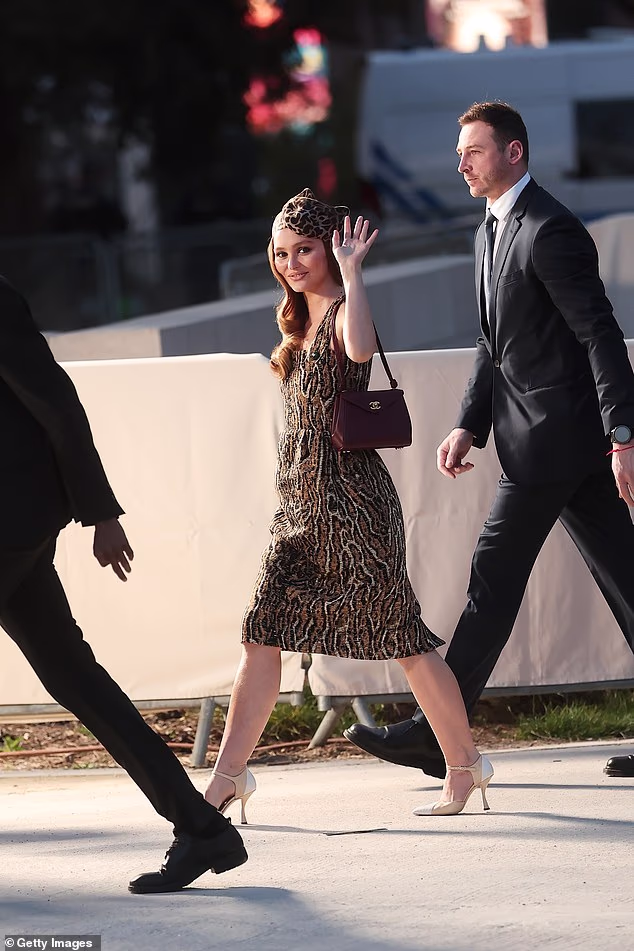 Lily boosted her height with nude heels and added a matching hat to her look