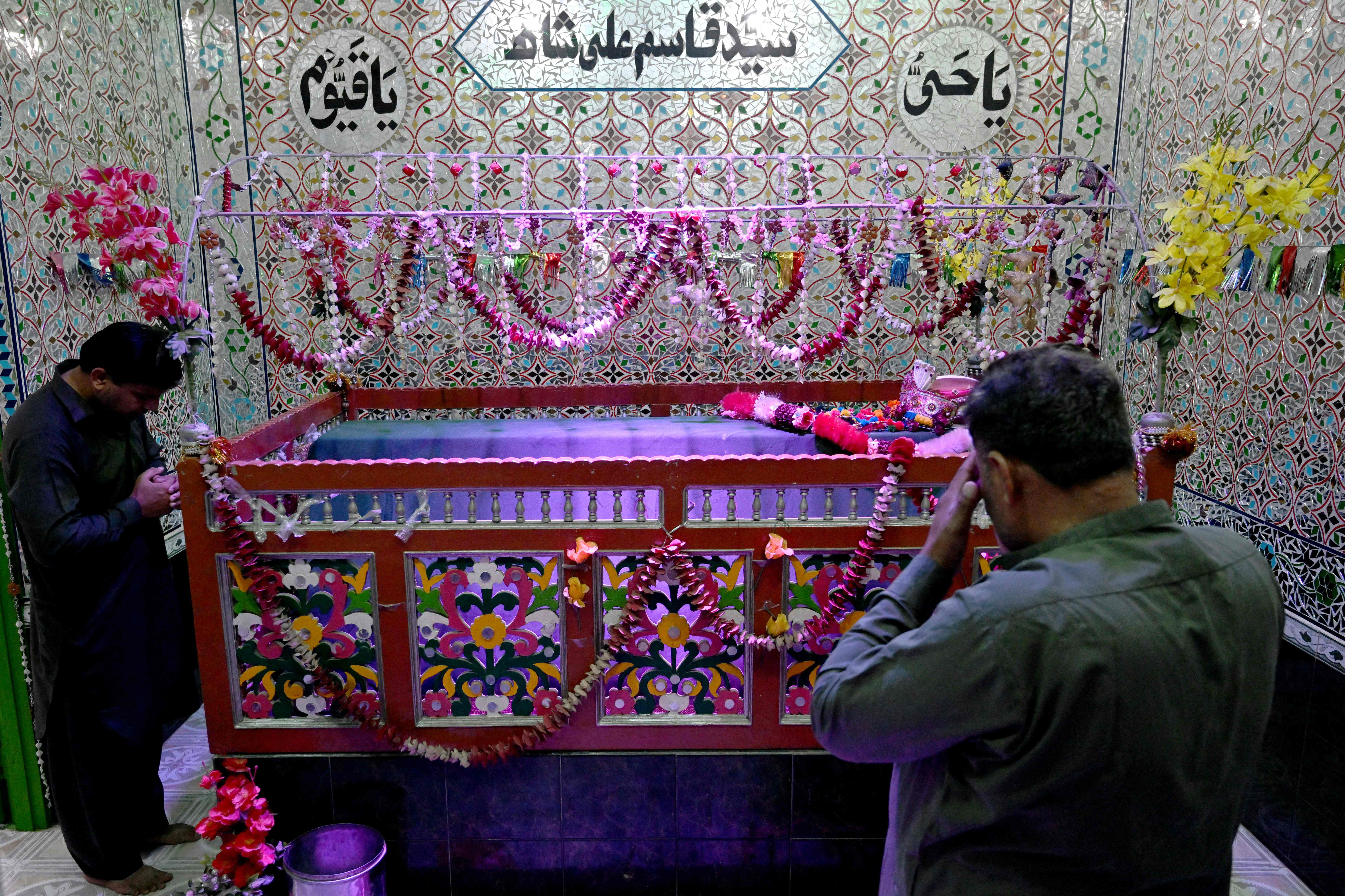 This photograph taken on February 26, 2026 shows Hindu men offering prayers inside a Sufi shrine during the Islamic holy fasting month of Ramadan, at Mithi in the Tharparkar district of Sindh province. Photo: AFP