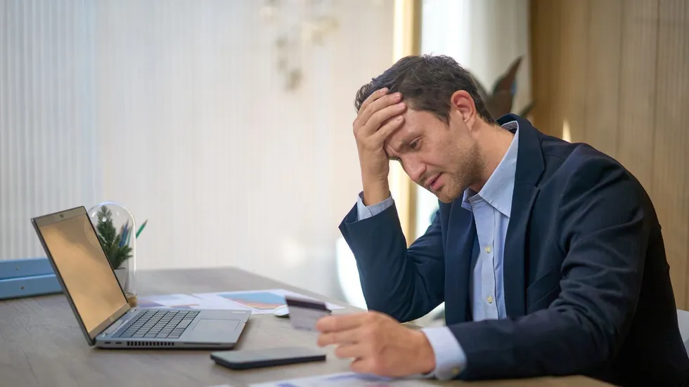 Man stressed at laptop