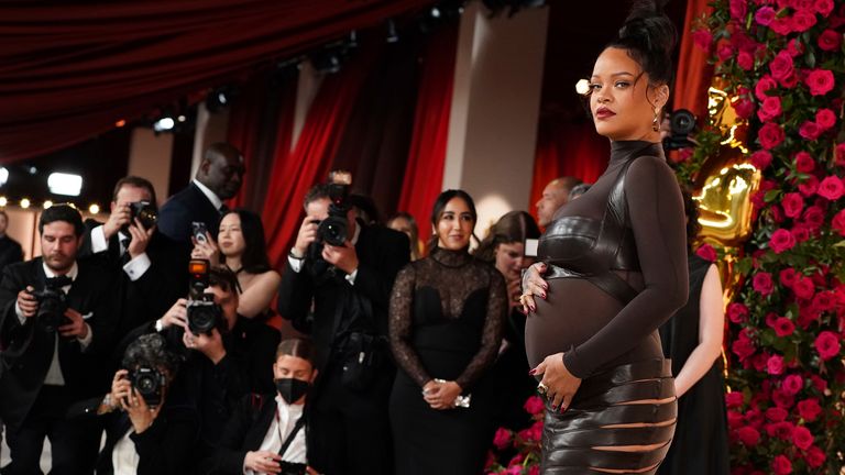 Re-defining maternity style, Rihanna wearing a bondage-inspired a custom dark brown Alaia ensemble to the Oscars in 2023. Pic: AP 