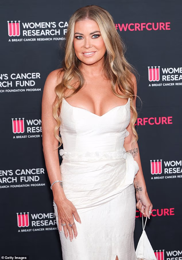 The Baywatch beauty was every inch the Hollywood siren in a low-cut ivory gown that clung to her enviable figure