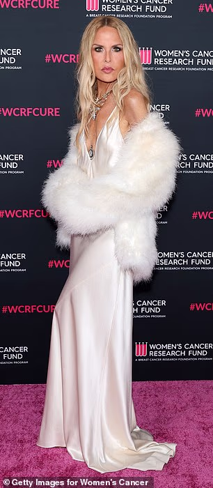 She layered the look with a white fur jacket