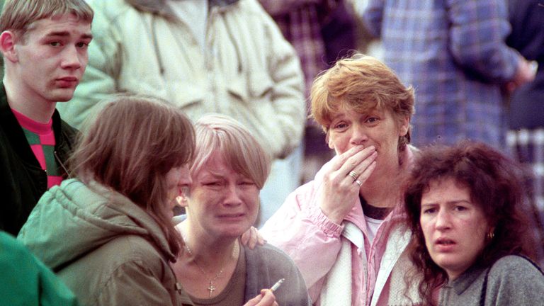Grieving families outside Dunblane primary school on the day of the shooting. Pic: PA