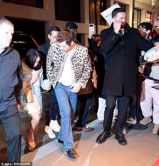 Harry looked stylish in an animal print jacket and blue jeans while by his side Zoe wore a light blue silk coat over a white dress paired with strappy heels