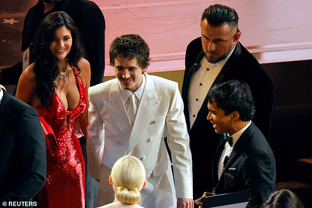 Kylie stunned in a shimmering red-number