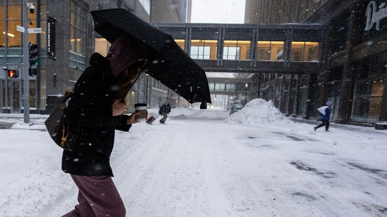 A woman walks during a snowstorm in Minneapolis, Minnesota. Pic: AP / Minnesota Star Tribune