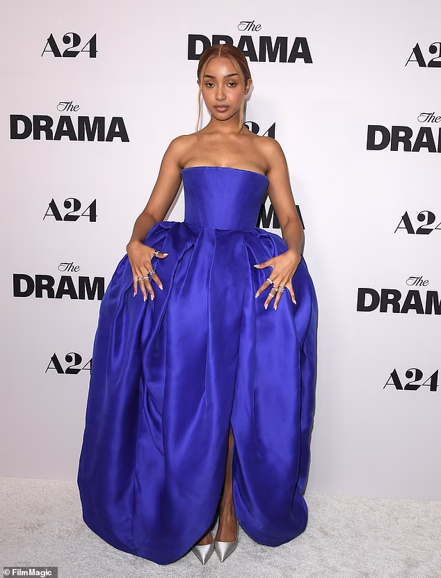 Two-time Grammy nominee PinkPantheress flaunted a hint of cleavage in her blue strapless ball gown with pannier side hoops and gold pumps selected by stylist Danyul Brown