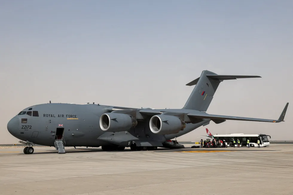 \u200bEvacuees disembark from a Royal Air Force Boeing C-17 transport aircraft after arriving in the UAE from Afghanistan in 2021