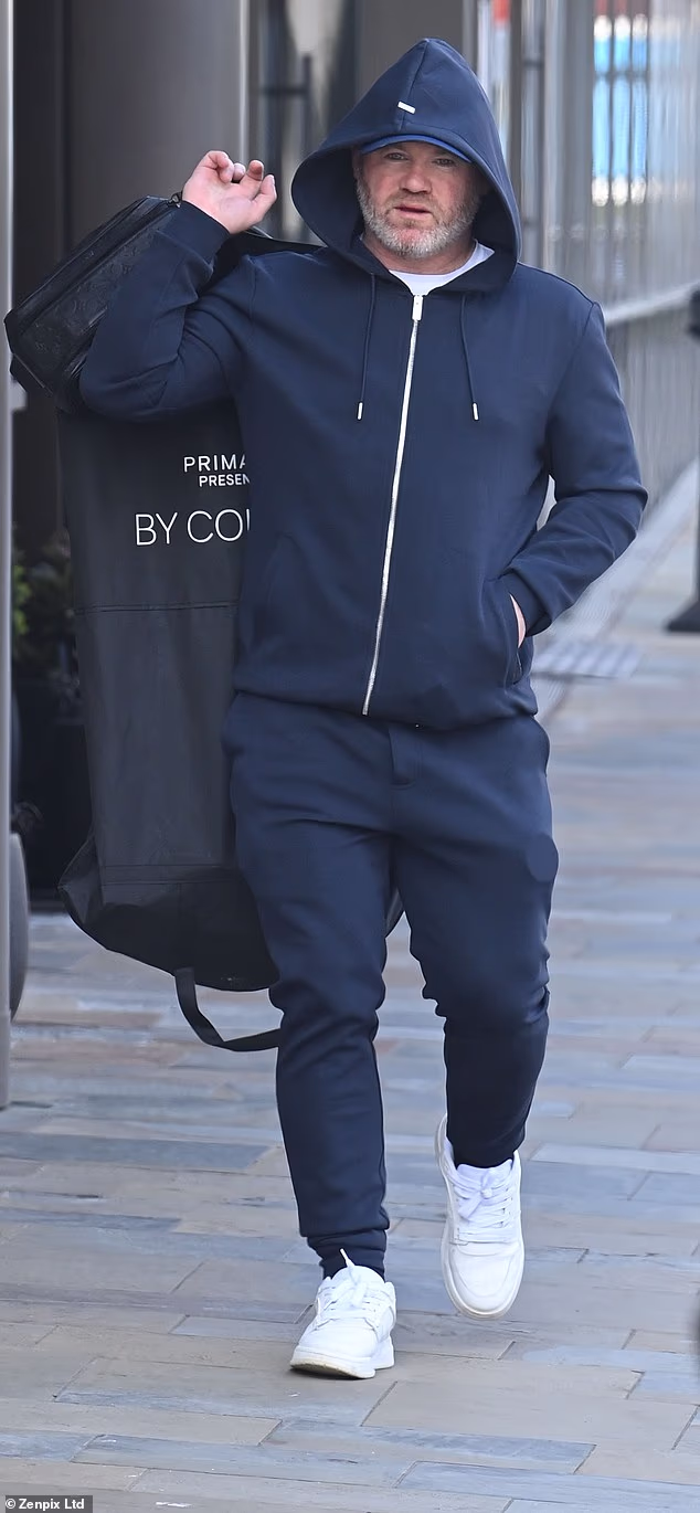 He opted for a navy zip-up hoodie and matching tracksuit bottoms as he made his way into the BBC studio, as well as a cap and white trainers