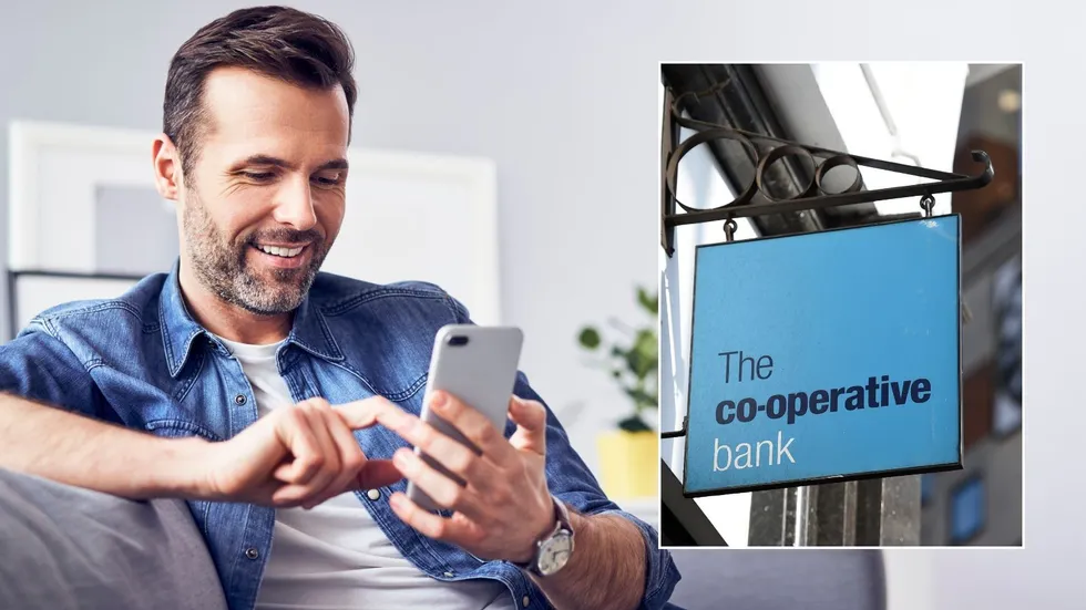 Man looking happy at phone and Co-operative Bank sign 