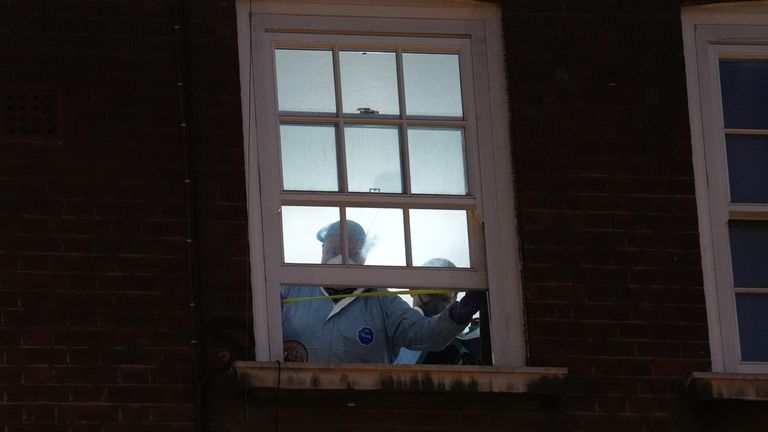 Forensic investigators at the third-floor window of the property. Pic: PA