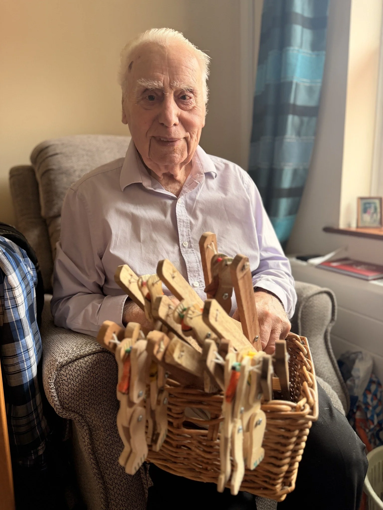 John Harris displays his handmade wooden toys