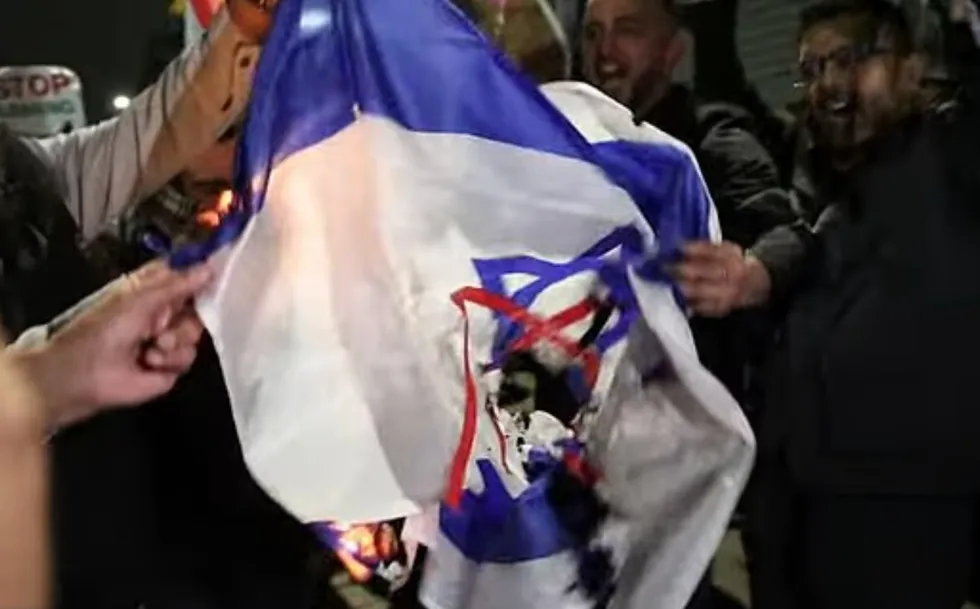Israeli flag being burned by protesters