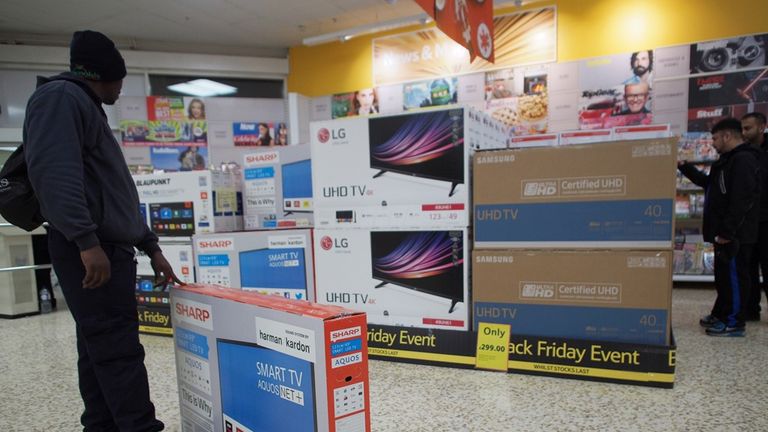 A customer buys a TV during a Black Friday sale. Pic: PA