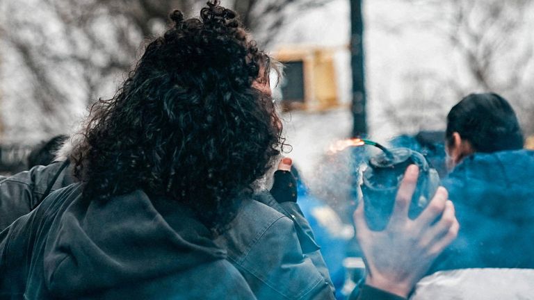 An alleged homemade bomb is hurled towards protesters. Pic: Reuters