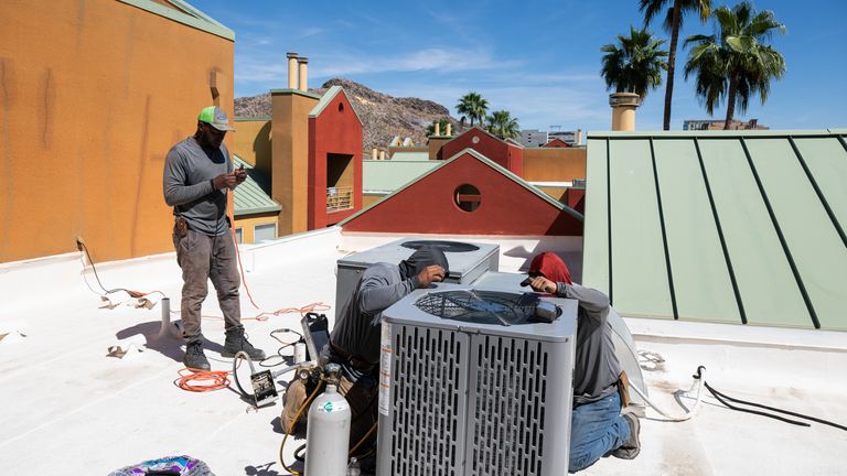 A new air conditioning unit is installed during record-breaking heat. Pic: AP