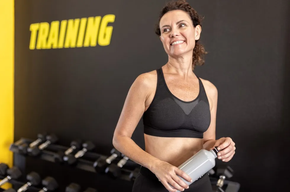 Woman in gym with water bottle